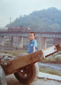 photo-from-grandmother-kim-jae-soon_s-family-album-the-picture-shows-park-chan-hyub-kim-jae-soon_s-youngest-son-against-the-background-of-the-suam-river-circa-1976